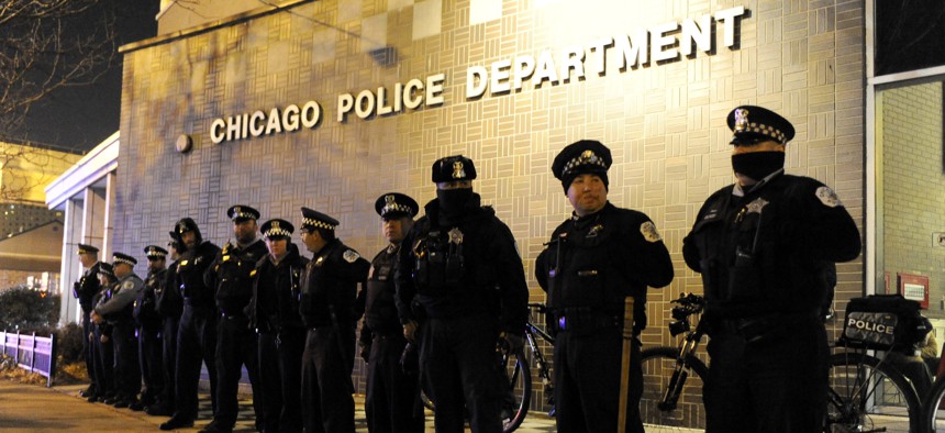 In this Nov. 24, 2015, file photo, Chicago police officers line up outside the District 1 central headquarters in Chicago, during a protest for the fatal police shooting of 17-year-old Laquan McDonald. 