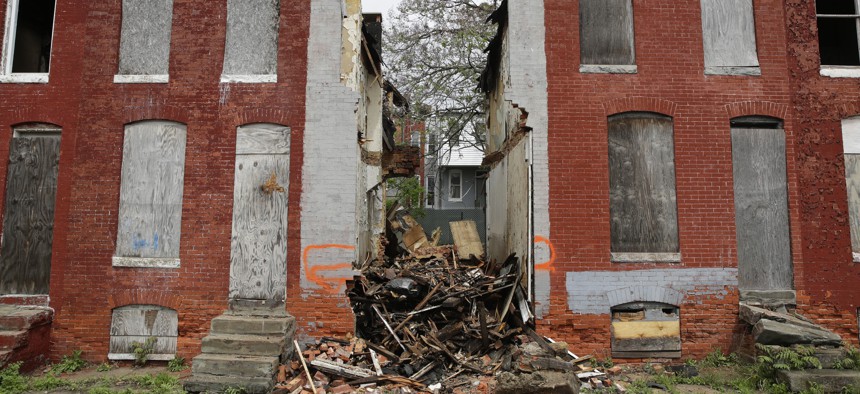 In this April 26, 2017 photo, debris remains where a demolished row house once stood in Baltimore, Maryland.
