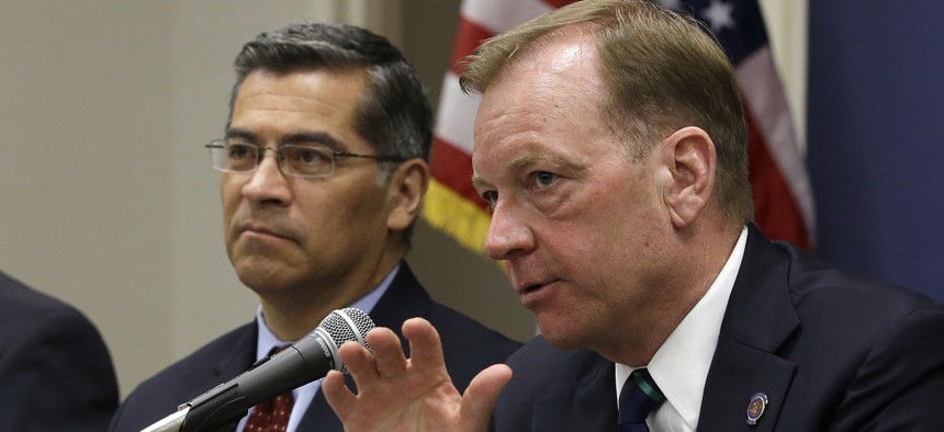 McGregor Scott, right, the United States Attorney for the Eastern District of California, accompanied by California Attorney General Xavier Becerra, discusses illegal marijuana farms hidden on public lands Tuesday, May 29, 2018, in Sacramento, Calif.
