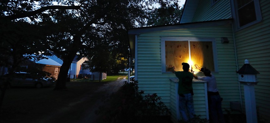 Russell Meadows, left, helps neighbor Rob Muller board up his home ahead of Hurricane Florence in Morehead City, North Carolina on Tuesday.