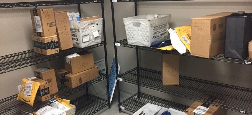 In this April 13, 2018, photo, packages from Internet retailers are delivered with the U.S. Mail in a apartment building mail room in Washington. 