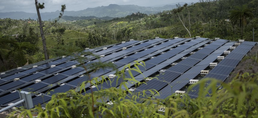 In this July 20 photo, solar panels installed by Tesla, power a community of 12 homes in the mountain town of Las Piedras, Puerto Rico. Las Piedras still doesn't have power off the national grid, more than 10 months after Hurricane Maria.