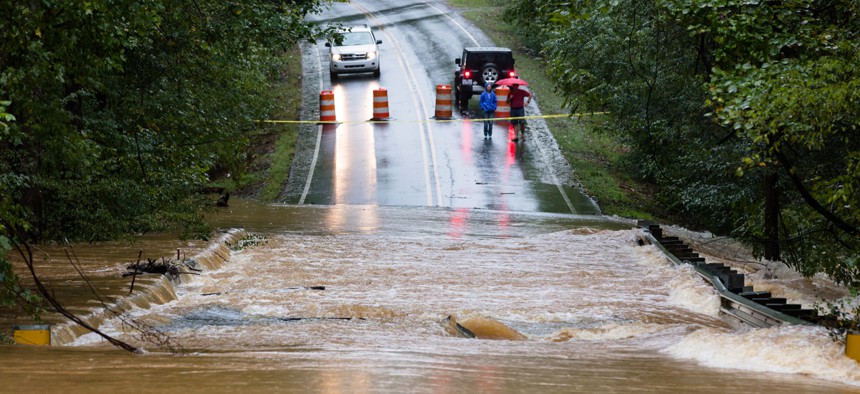 Waxhaw, North Carolina - September 16, 2018: Motorists inspect a road flooded by rain from Hurricane Florence.