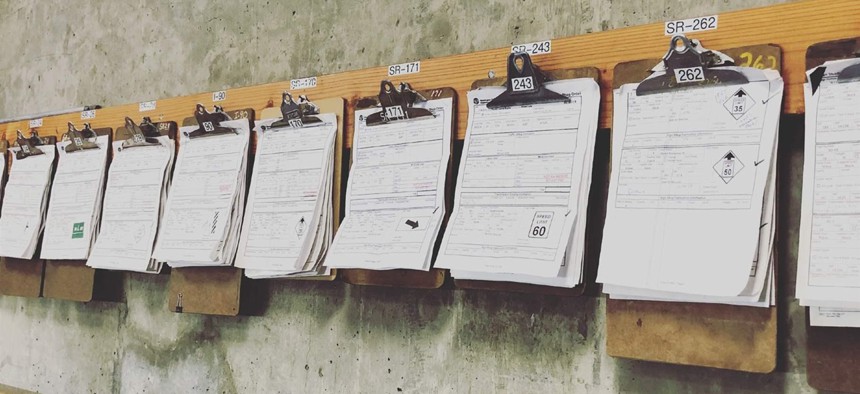 Clipboards with paper inspection sheets hang on the wall of a Washington State Department of Transportation maintenance office in 2014. Maintenance field staffers now use iPads and apps to inspect everything from guardrails to drainage systems.