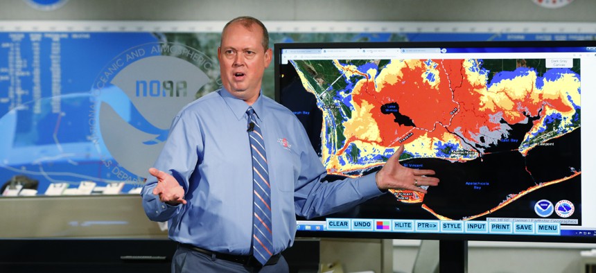National Hurricane Center director Ken Graham, gestures as he talks about storm surge during a televised update on the status of Hurricane Michael, Tuesday, Oct. 9, 2018, at the Hurricane Center in Miami.