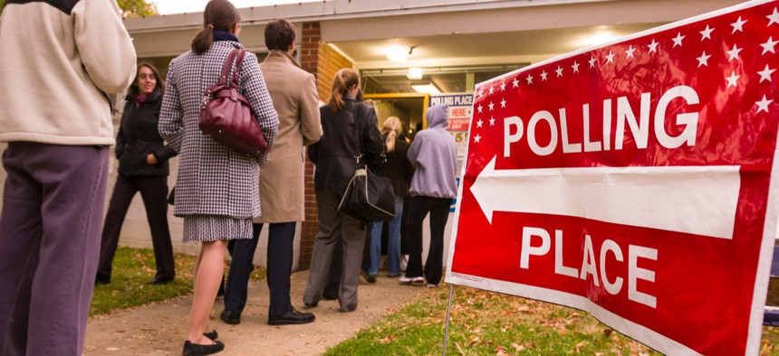 Voting polling place sign and people lined up on election day in 2008.