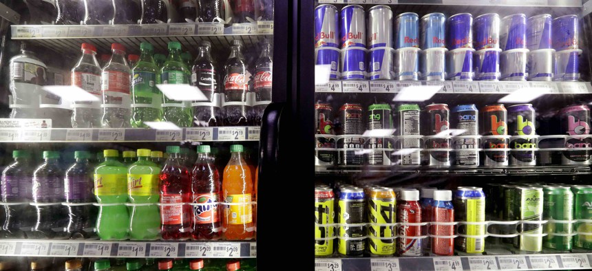 In this Monday, Oct. 1, 2018 photo, soft drinks fill a drink cooler in a convenience store in Kent, Wash.