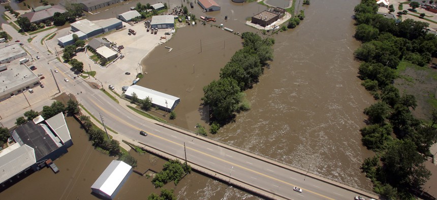 A swollen Iowa River flows under the Benton Street bridge in Iowa City, Iowa, on Monday, June 16, 2008. 