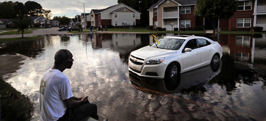 Augustin Dieudomme looks out at the flooded entrance to his apartment complex near the Cape Fear River as it continued to rise in the aftermath of Hurricane Florence in Fayetteville, North Carolina, on Sept. 18.