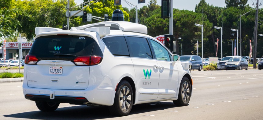 Waymo self-driving car cruising on a street in Silicon Valley in 2017.