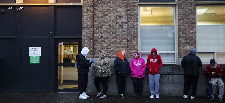 People wait in line outside a Washington state methadone clinic in 2017.