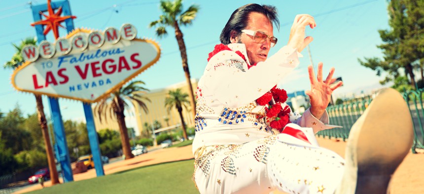 An Elvis impersonator at the 'Welcome to Fabulous Las Vegas' sign, an enduring brand.