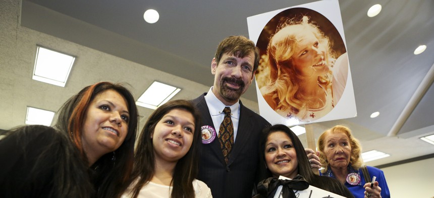 Dr. Henry T. Nicholas III, who has funded campaigns for Marsy's Law measures across the country, poses with victims of violence during the Orange County Victims' Rights March and Rally, Friday, April 26, 2013, in Santa Ana, Calif. 