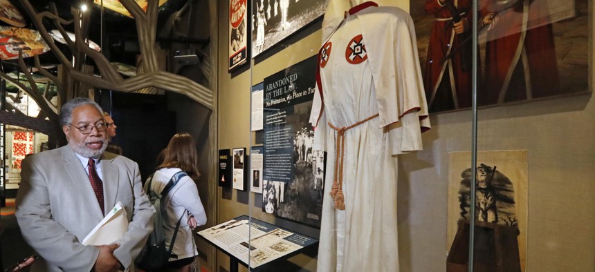 Lonnie Bunch, founding director of the National Museum of African American History and Culture, looks at a Ku Klux Klan display in the new Mississippi Civil Rights Museum in Jackson last April. African-American museums and historic sites are flourishing. 
