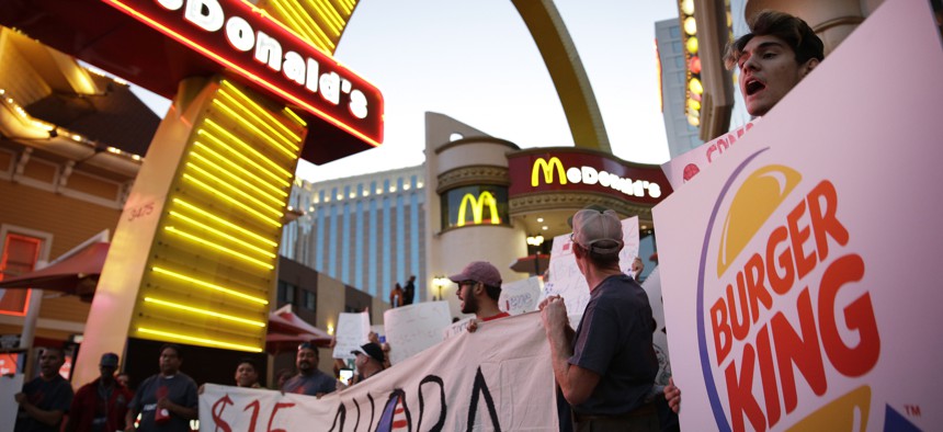 In this Sept. 4, 2014 file photo, protestors, including Kris Varrette, right, chant for increased wages and union rights at fast food restaurants in Las Vegas.