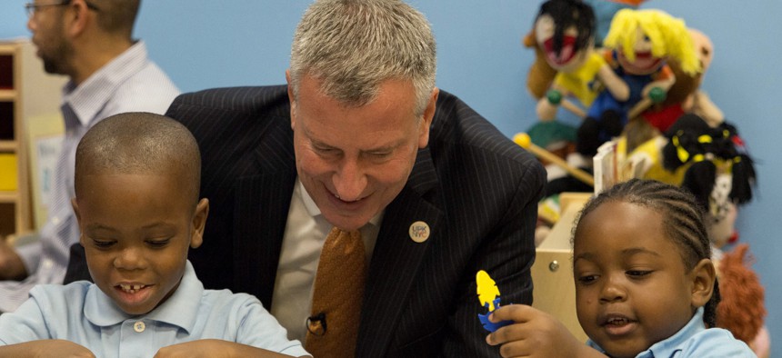 In this Sept. 4, 2014 file photo, New York Mayor Bill de Blasio visits a pre-K program in Brooklyn on the first day of the mayor's ambitious expansion of early childhood education.