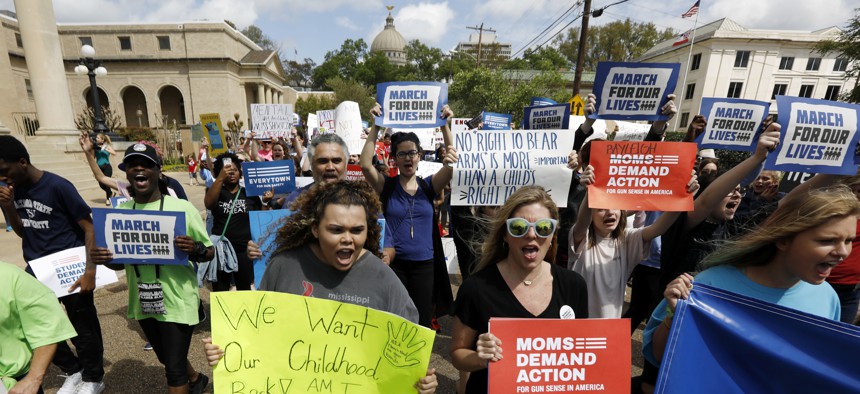 Several hundred students, parents, concerned citizens and anti-gun advocates marched in downtown Jackson, Miss., March 24, 2018, to demand stricter gun laws in the U.S. 