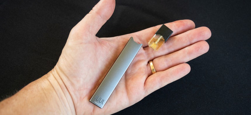  A hand holding an e-cigarette that was found at a 2018 high school graduation ceremony in California.