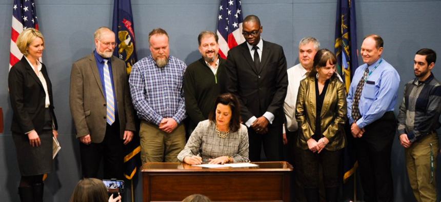 Michigan Gov. Gretchen Whitmer signs her first executive director on Wednesday.