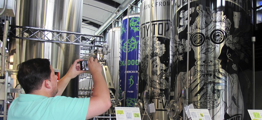 A tourist from New York City visits the Alchemist brewery in Stowe, Vermont. Vermont is trying to tempt tourists into becoming residents, part of an economic development strategy focused on luring new workers, rather than businesses.
