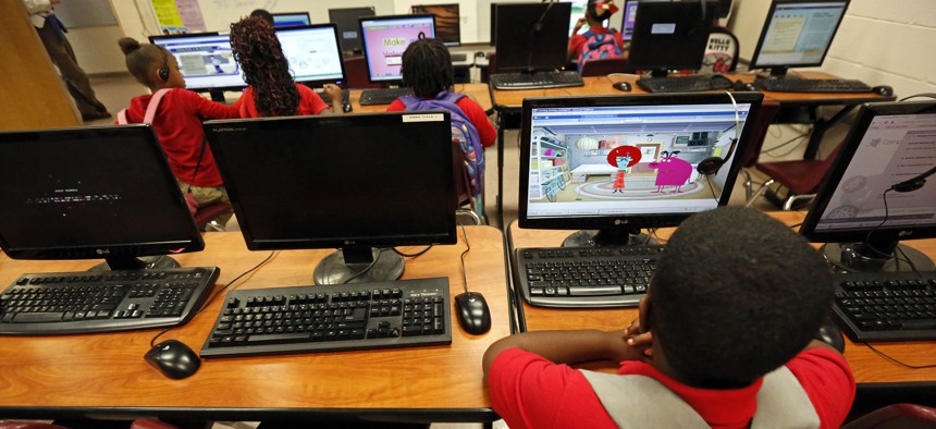 In this Oct. 23, 2014 photograph, a young boy uses a computer during an after-school session at the Durant elementary school in Durant, Miss. 