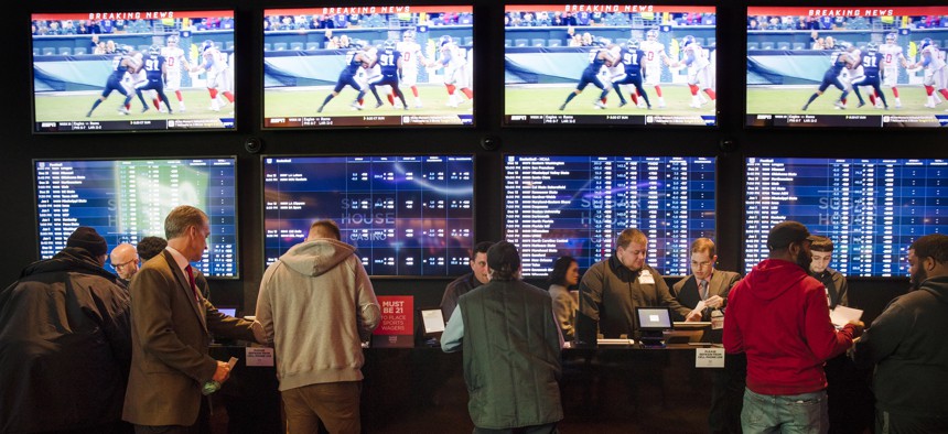 In this Thursday, Dec. 13, 2018, file photo, gamblers place bets in the temporary sports betting area at the SugarHouse Casino in Philadelphia. 