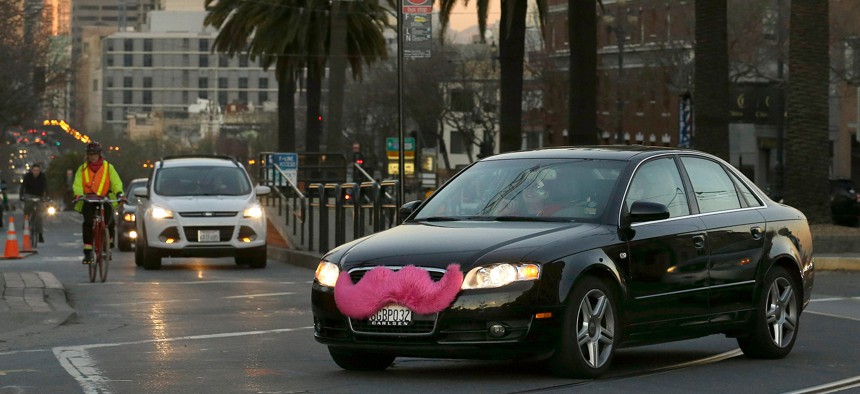 In this Jan. 17, 2013, file photo, a Lyft car crosses Market Street in San Francisco.