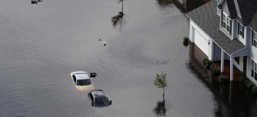 Cars are submerged in a neighborhood in the aftermath of Hurricane Florence in Fayetteville, N.C., Monday, Sept. 17, 2018.