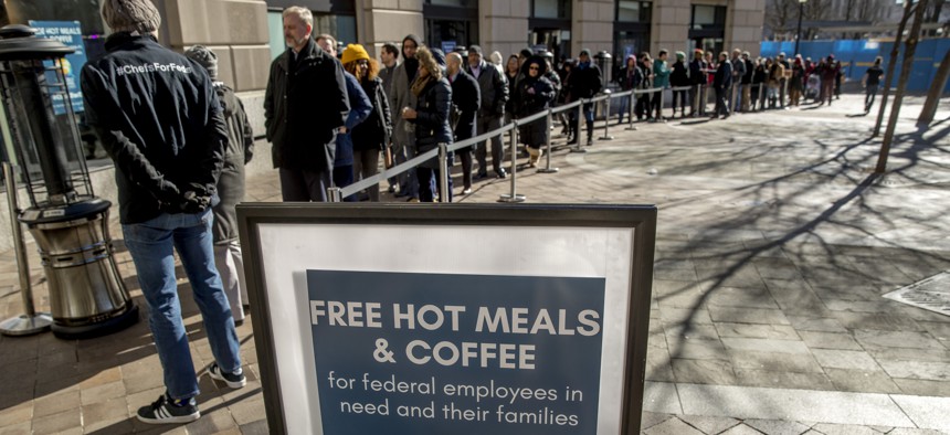 Furloughed workers wait in line to receive food and supplies from World Central Kitchen, the not-for-profit organization started by Chef Jose Andres in Washington, Tuesday, Jan. 22, 2019. 