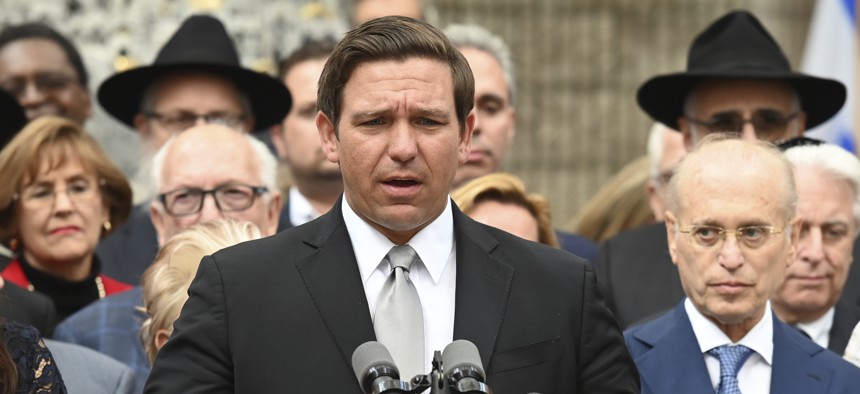  Florida Gov. Ron DeSantis stands with members of the Jewish community in Boca Raton on Jan. 15. DeSantis announced he is preparing to set sanctions on Airbnb over the home-sharing platform's decision not to list properties in the West Bank. 