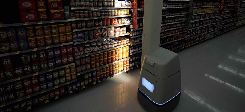 In this Nov. 9, 2018, file photo, a Bossa Nova robot scans shelves to help provide associates with real-time inventory data at a Walmart Supercenter in Houston.