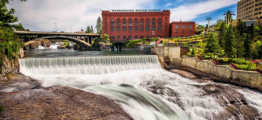Falls and the Washington Water Power building along the Spokane river in Spokane, Washington.