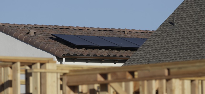 Solar panels are installed on the rooftop of a home in a new housing project in Sacramento, California.