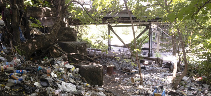 This July 31, 2017, file photo shows trash including discarded syringes and other rubbish in an open-air heroin market that has thrived for decades, slated for cleanup along train tracks a few miles outside the heart of Philadelphia.