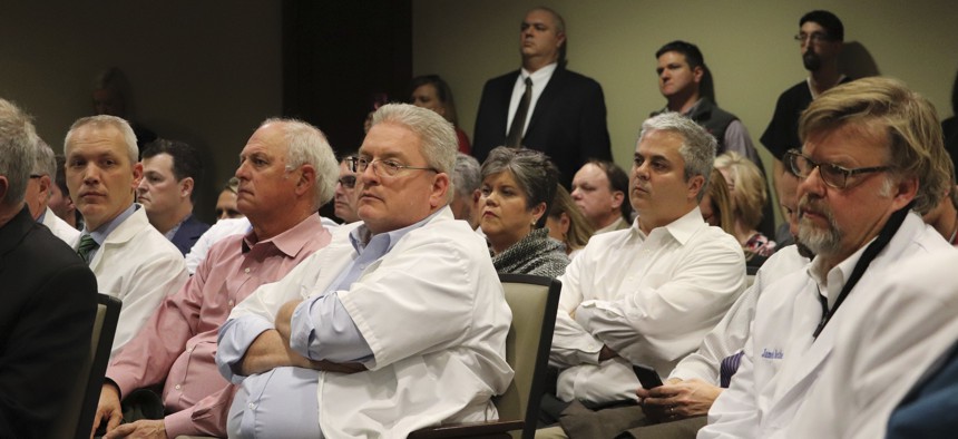 Pharmacists packed a state Capitol hearing room last year in Little Rock, Ark., to complain about low reimbursement rates from pharmacy benefit managers within state managed insurance plans.