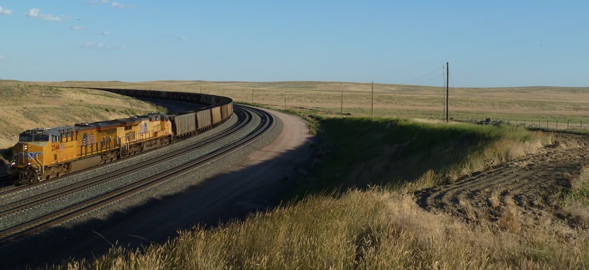 Locomotives and coal train rounding a track curve in Powder River Basin of Wyoming.