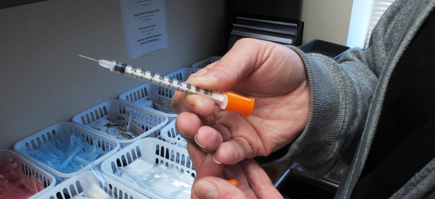 Sharing needles to inject heroin is one way hepatitis C is transmitted. Louisiana and Washington hope to eradicate the disease through innovative payment models adapted from Netflix.