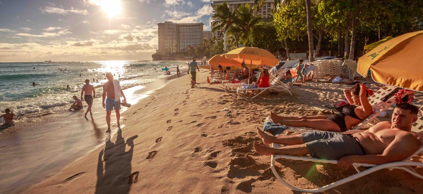 Beachgoers in Hawaii, a state that has consistently performed well on Gallup's "well-being" index.