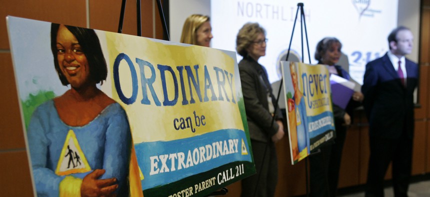 A poster urging people to become foster parents is displayed at a news conference at Children's Hospital on Jan. 30, 2008, in Cincinnati. States are now turning to new methods, like online ads, to recruit foster parents. 
