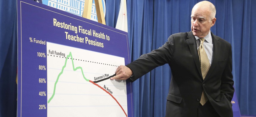 Former California governor, Jerry Brown, points to a chart showing his plan to fund teacher pensions in May of 2014.