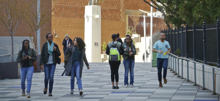 People walk near the main entrance to the Borough of Manhattan Community College in New York. At least 15 states, including New York, offer grants that allow some students to attend public colleges tuition-free.