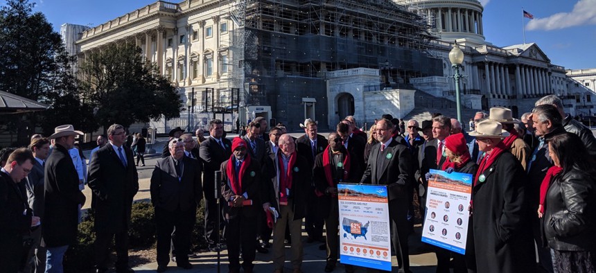 County officials gathered outside the U.S. Capitol on Tuesday to push for public lands payment programs.