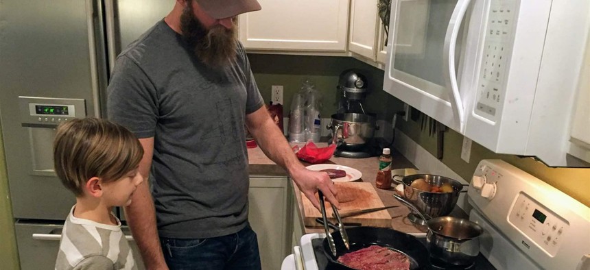 Nate Lindskoog and his son Jett, 8, cook venison tacos in their Nampa, Idaho, home. The deer was killed by a car a year earlier.