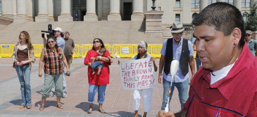 Chebon Kernell beats a drum and sings as participants dance during a 2013 rally in Oklahoma City in support of a biological father trying to get his daughter back under the Indian Child Welfare Act.