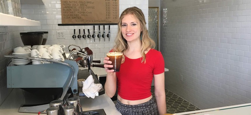 Anna Buck, a barista, holds a cup of CBD-infused cold brew at Blue Sparrow Coffee in Denver. Federal regulators say businesses that add cannabidiol to food are essentially adding prescription drugs into the food supply.