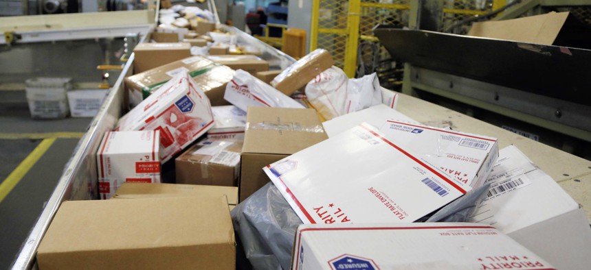 Packages travel on a conveyor belt for sorting at the main post office in Omaha, Neb. 