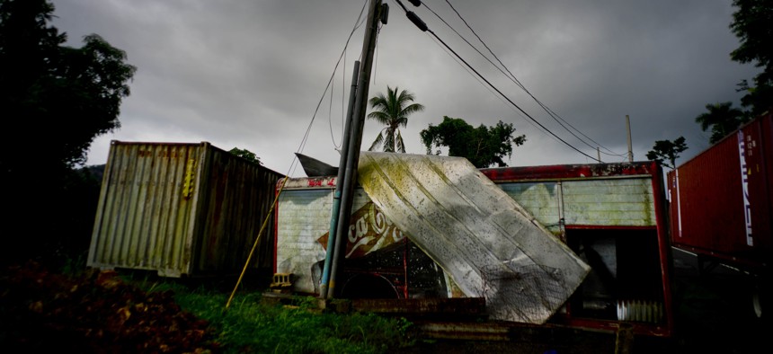 In this Sept. 7, 2018 photo, a Coca-Cola trailer destroyed a year before by Hurricane Maria stands on the side of the road in Orocovis, Puerto Rico. 