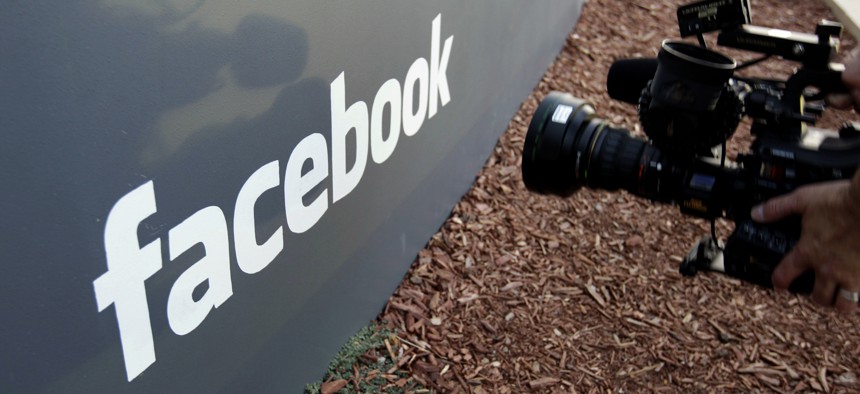 A television photographer shoots the sign outside of Facebook headquarters in Menlo Park, Calif. 