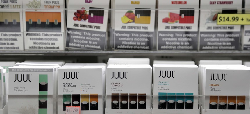 Juul products, bottom row, are displayed at a smoke shop in New York, Thursday, Dec. 20, 2018. 