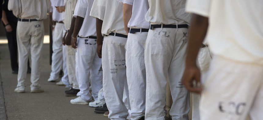 In this June 18, 2015 file photo, prisoners stand in a crowded lunch line during a prison tour at Elmore Correctional Facility in Elmore, Ala. 